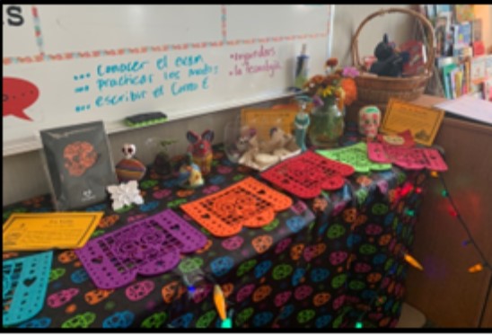 An altar for Día de Los Muertos that contains calaveras (skulls) and marigolds.