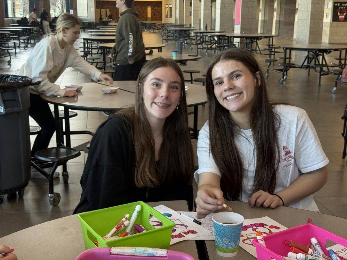 Sisters KJ and Chloe Jacobson celebrate at Unified club's Cookies, Crafts, and Cocoa event in the Ferris Commons. Photo provided by Unified Club